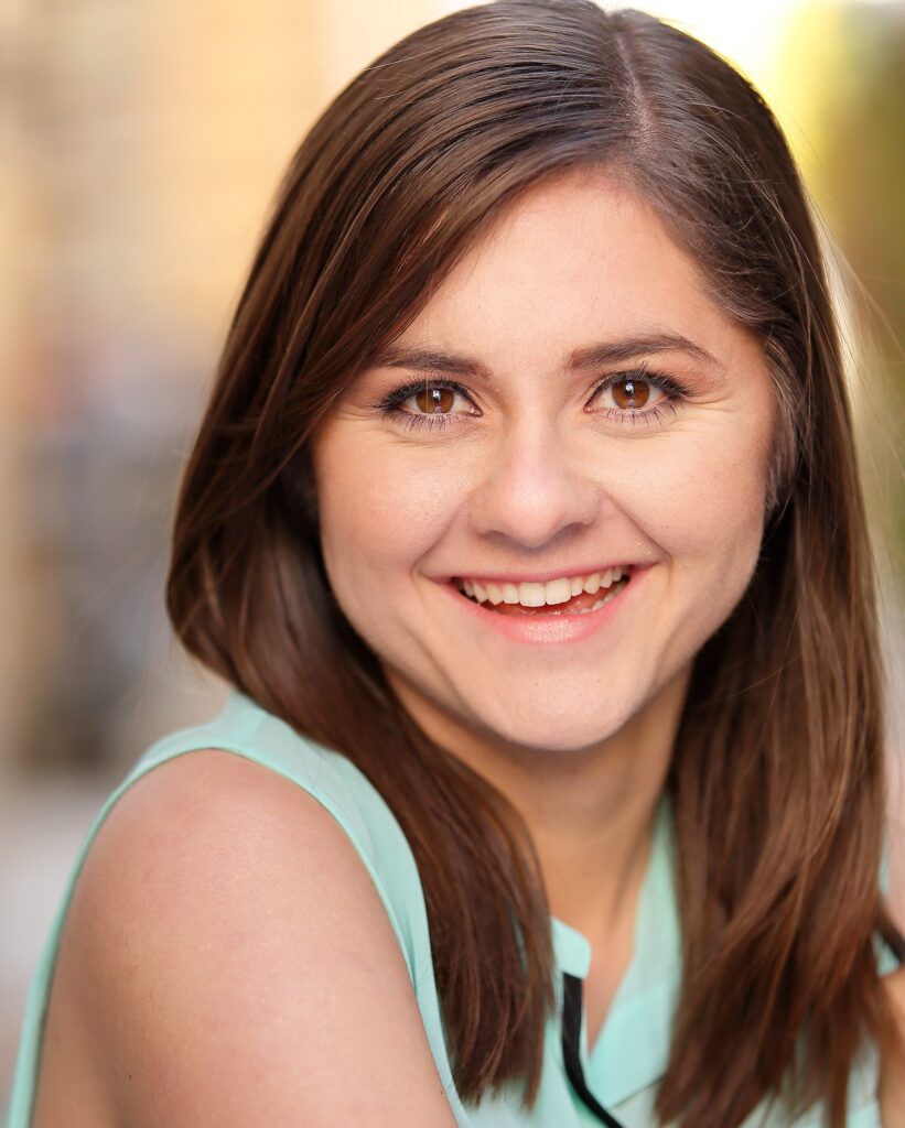 Melissa is a young girl with long brown hair, wearing a sleeveless light blue blouse