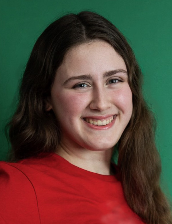 Nadia is a girl with long brown hair, wearing a dress shirt